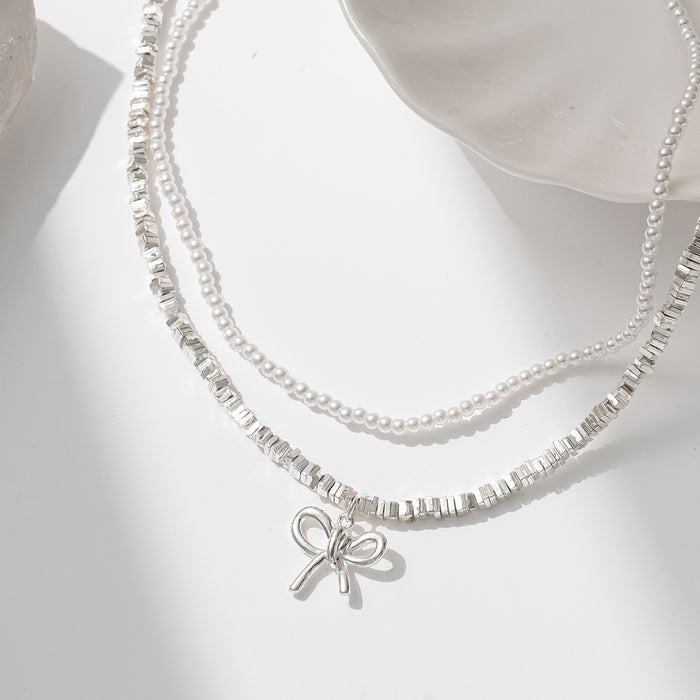 Wholesale Cross border new bow necklace with simple and high-end feel, retro double-layer layered design, imitation pearl collarbone chain