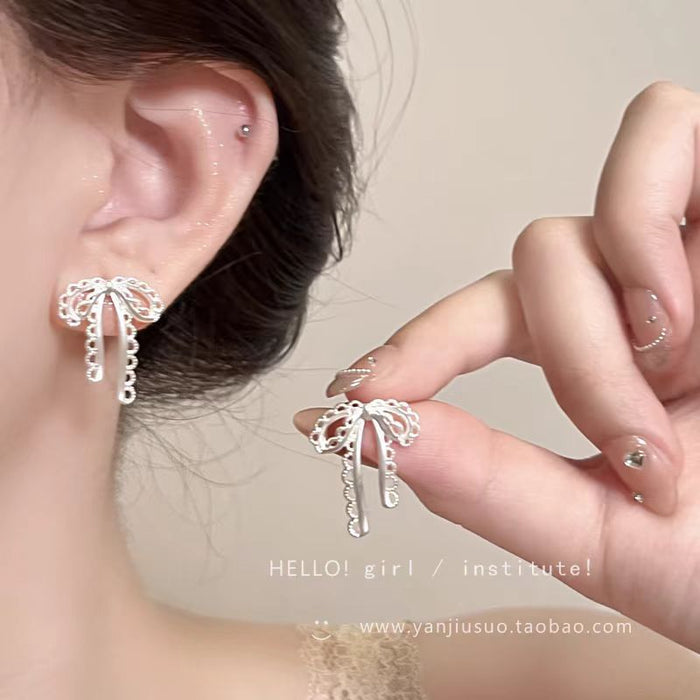 Wholesale Silver hollow bow earrings with a niche and high-end feel, designed earrings with a sense of sophistication