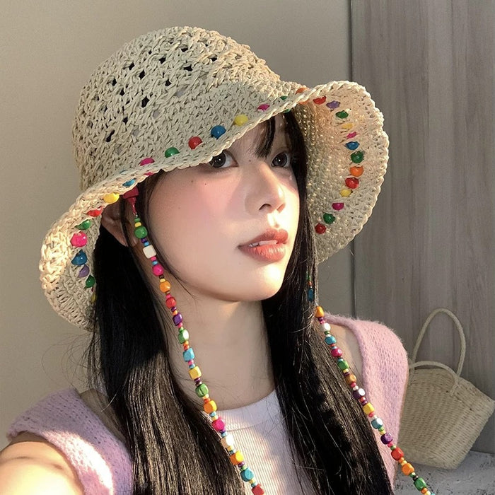 Wholesale Colorful wooden bead grass hat for women in summer with hollowed out large brim for sun protection and foldable fisherman hat