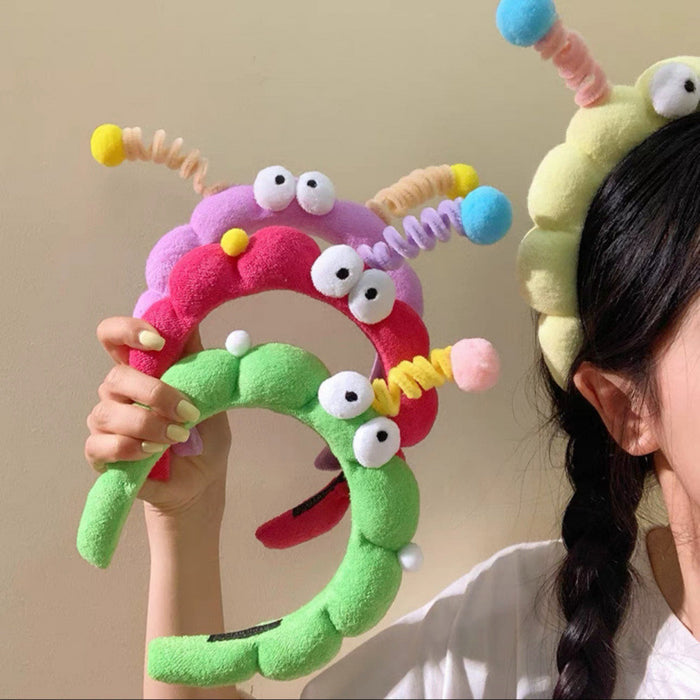 Wholesale Cute girl' s twistable hairband with big-eyed plush toy design.