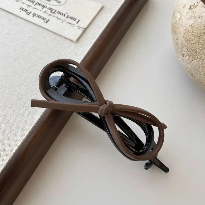 Wholesale Temperament leather bow twist clip hair with a high-end feel, straight clip headband accessory