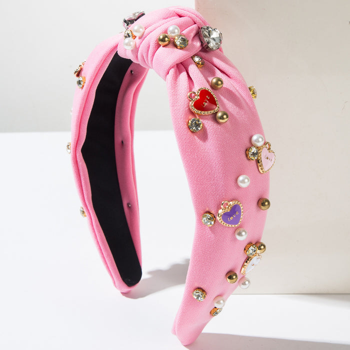 Wholesale Valentine' s Day headband with pearl-encrusted alloy letter and heart-shaped embellishments