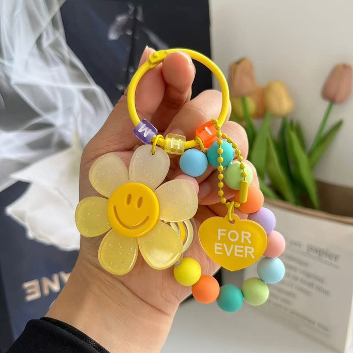 Wholesale Cute letter sunflower bag pendant with smiling face, colorful handmade bead key chain