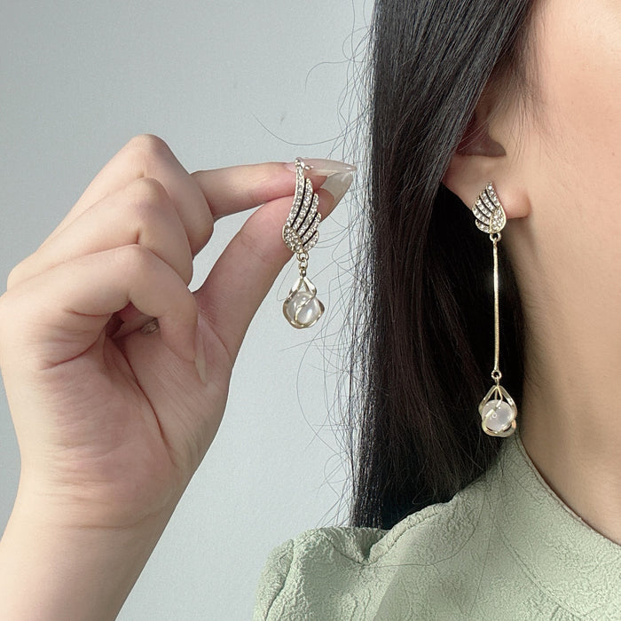 Wholesale Trendy AB asymmetrical diamond studded wing tassel cat eye stone earrings with atmospheric and exquisite earrings