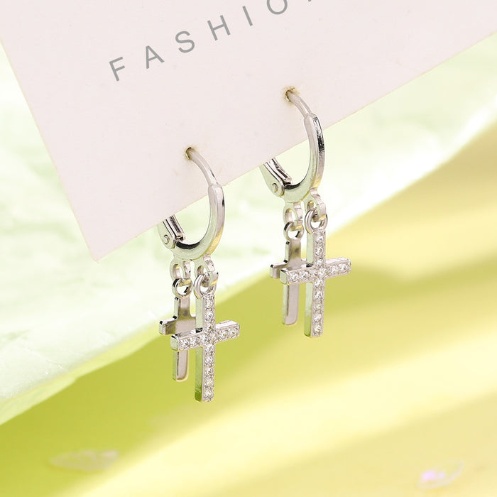 Wholesale Double layered cross studded diamond earrings with neutral tassels and asymmetrical cross shaped ear loops