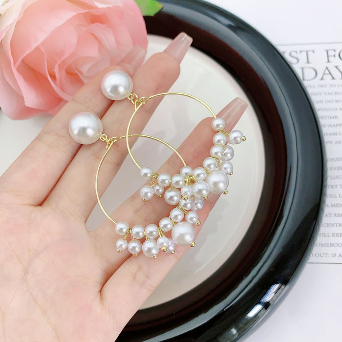 Wholesale Hollow out circle long pearl earrings with a minimalist and slimming style, featuring tassel earrings