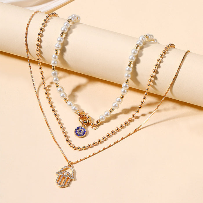 Wholesale New exaggerated jewelry alloy diamond inlaid multi-layer necklace for women, pearl eyes, palm pendant