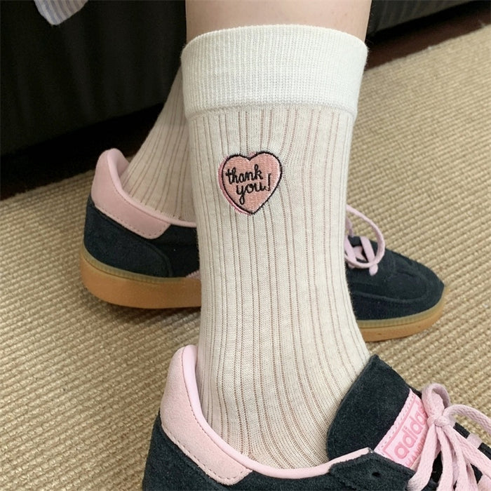 Wholesale Hollow out thin heart-shaped embroidered socks in a pile, tube socks