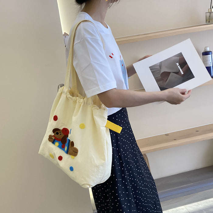 Wholesale New cute cartoon embroidered drawstring shoulder bag, fashionable and simple canvas bag, large capacity tote bag