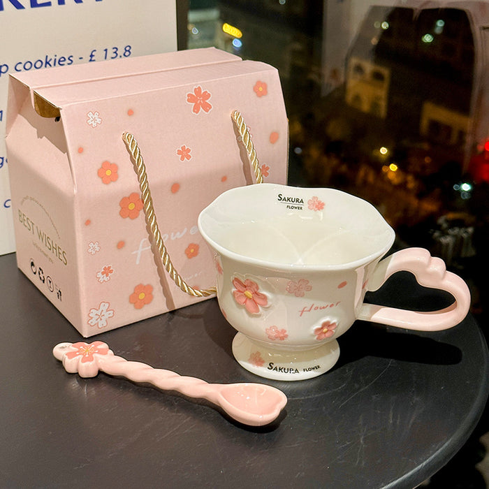 Wholesale Pink ceramic stemmed cup with cherry blossom relief design and spoon