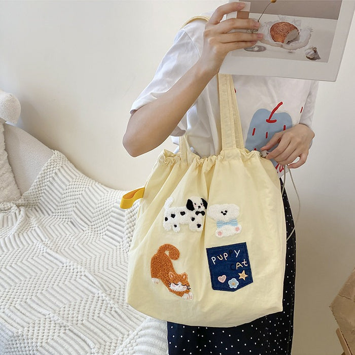 Wholesale New cute cartoon embroidered drawstring shoulder bag, fashionable and simple canvas bag, large capacity tote bag