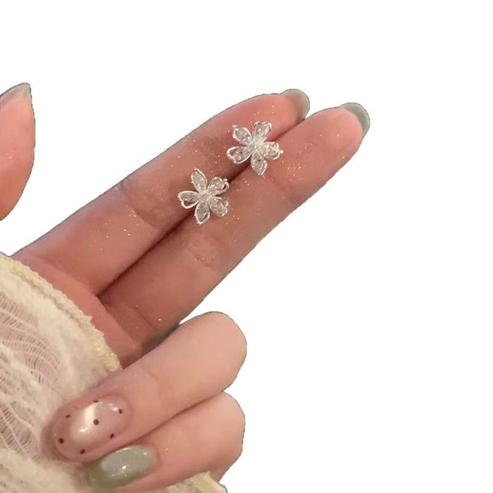 Wholesale Simple and compact hollow out sparkling diamond flower earrings with a high-end feel, elegant temperament, niche design, and earrings