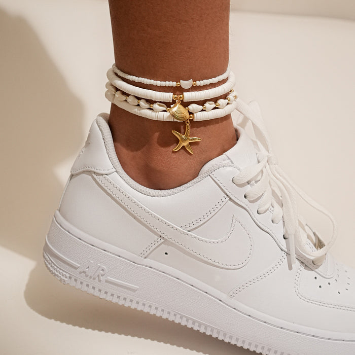 Wholesale Four piece set of shell ankle chains, fashionable and simple, stacked with multiple layers of rice beads woven ankle chains