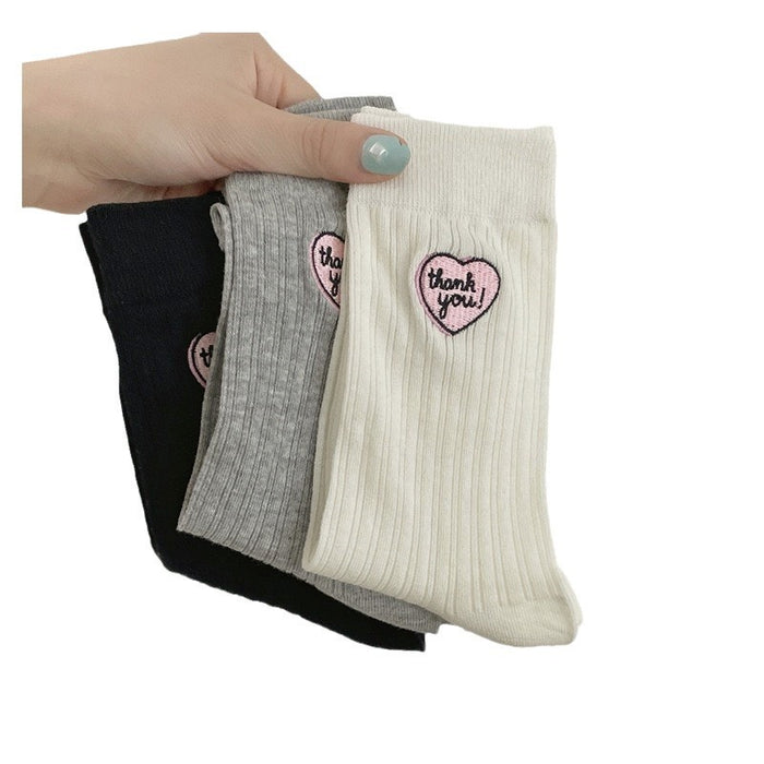 Wholesale Hollow out thin heart-shaped embroidered socks in a pile, tube socks