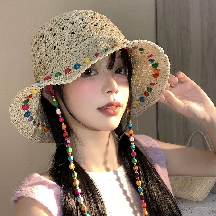 Wholesale Colorful wooden bead grass hat for women in summer with hollowed out large brim for sun protection and foldable fisherman hat