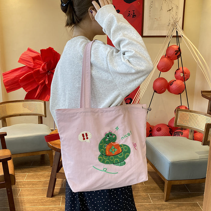 Wholesale Niche cartoon embroidered shoulder bag, simple and large capacity drawstring canvas bag, commuting tote bag for work