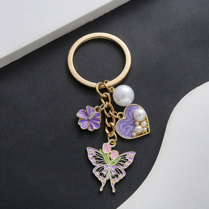 Wholesale Oil-dripping purple heart-shaped pearl tulip flower butterfly metal keychain