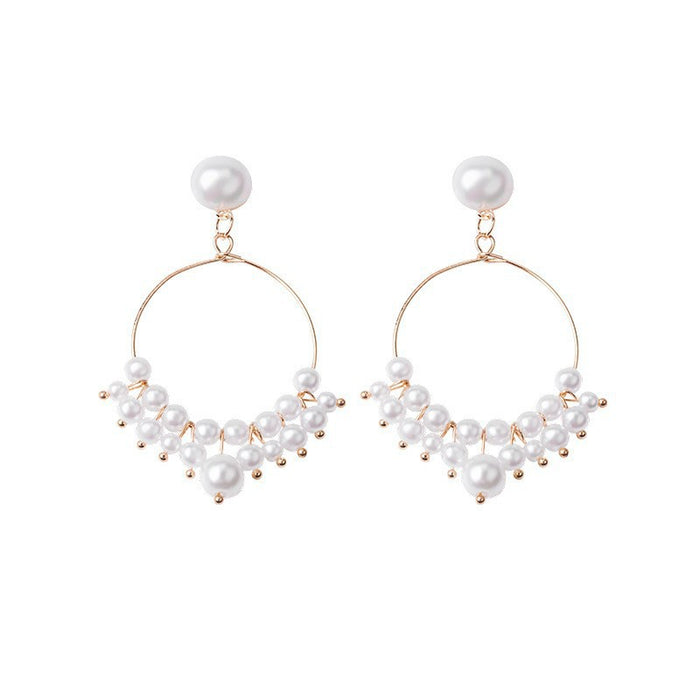 Wholesale Hollow out circle long pearl earrings with a minimalist and slimming style, featuring tassel earrings