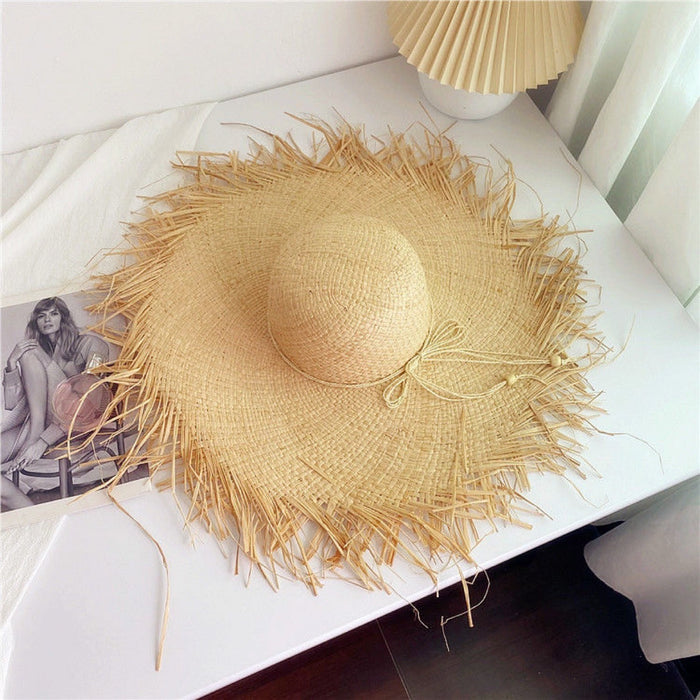 Wholesale Big brim frayed Lafite grass hat women's beach hat for beach vacation, sun protection and sunshade hat