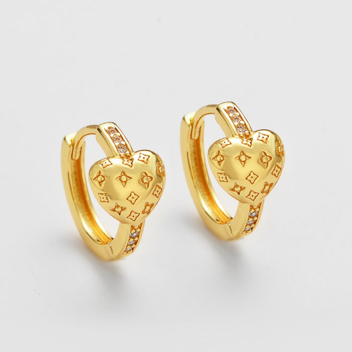 Wholesale Zirconia-studded heart-shaped metal earrings with a patterned design.