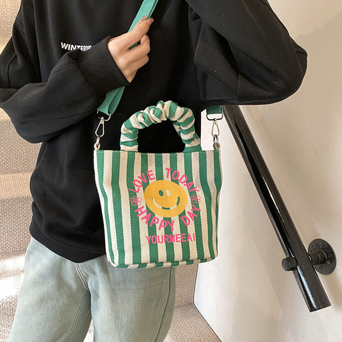 Wholesale Canvas bag, cute smiling face handbag, striped crossbody bag, commuting shoulder bag