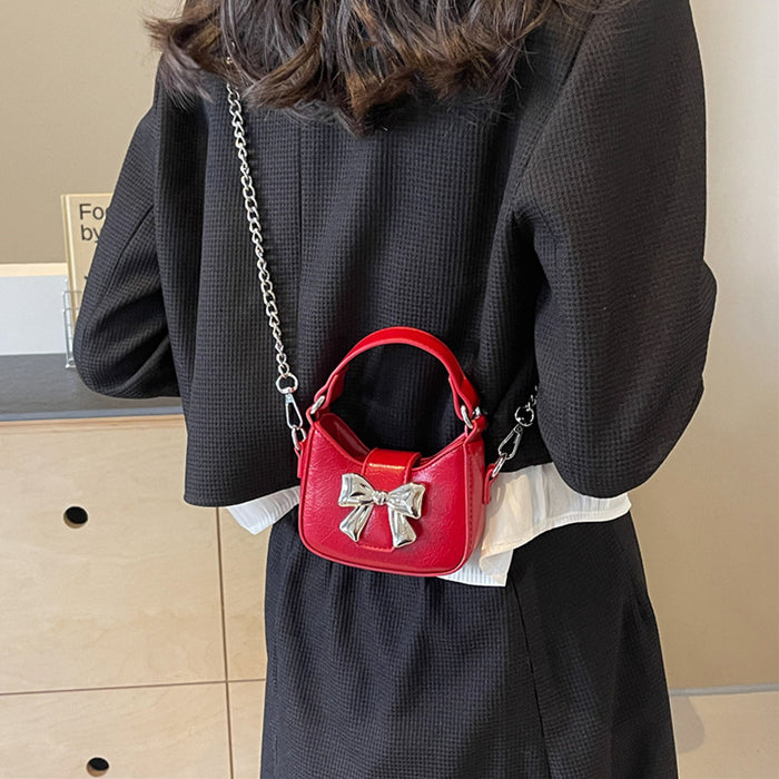 Wholesale New retro oil leather handbag with shiny bow and chain crossbody bag