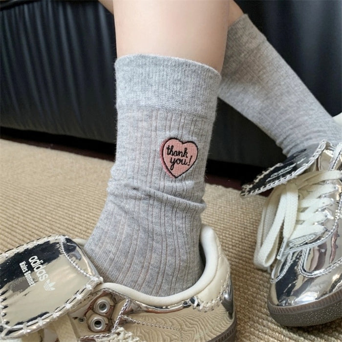 Wholesale Hollow out thin heart-shaped embroidered socks in a pile, tube socks