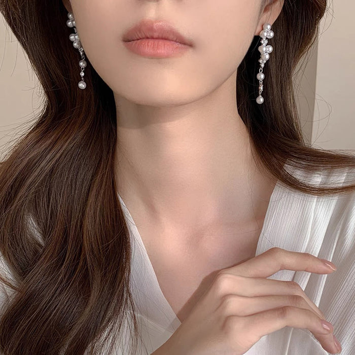 Wholesale Elegant long pearl ear clip without ear hole tassel earrings, fashionable and light luxury