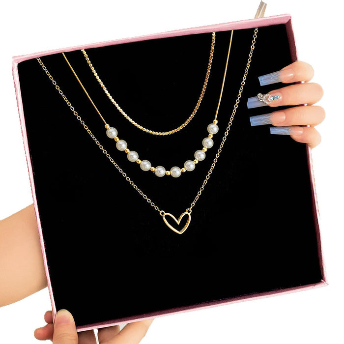 Wholesale Fashionable imitation pearl heart-shaped hollow pendant necklace, exquisite, high-end, versatile, multi-layer stacked collarbone chain
