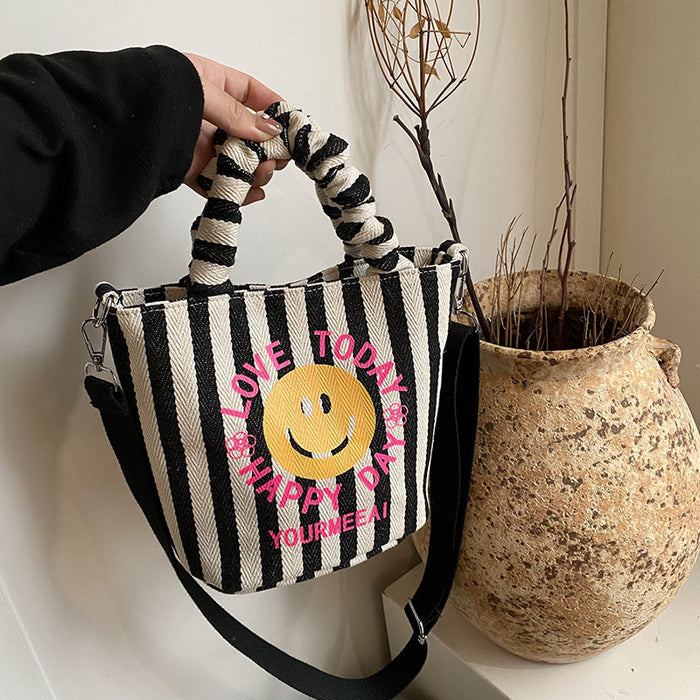 Wholesale Canvas bag, cute smiling face handbag, striped crossbody bag, commuting shoulder bag