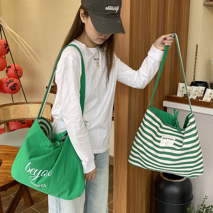 Wholesale New fashionable striped canvas bag with simple and large capacity letter printed double-sided crossbody bag, casual commuting shoulder bag