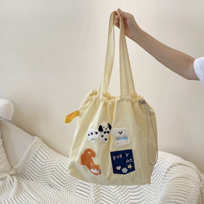 Wholesale New cute cartoon embroidered drawstring shoulder bag, fashionable and simple canvas bag, large capacity tote bag