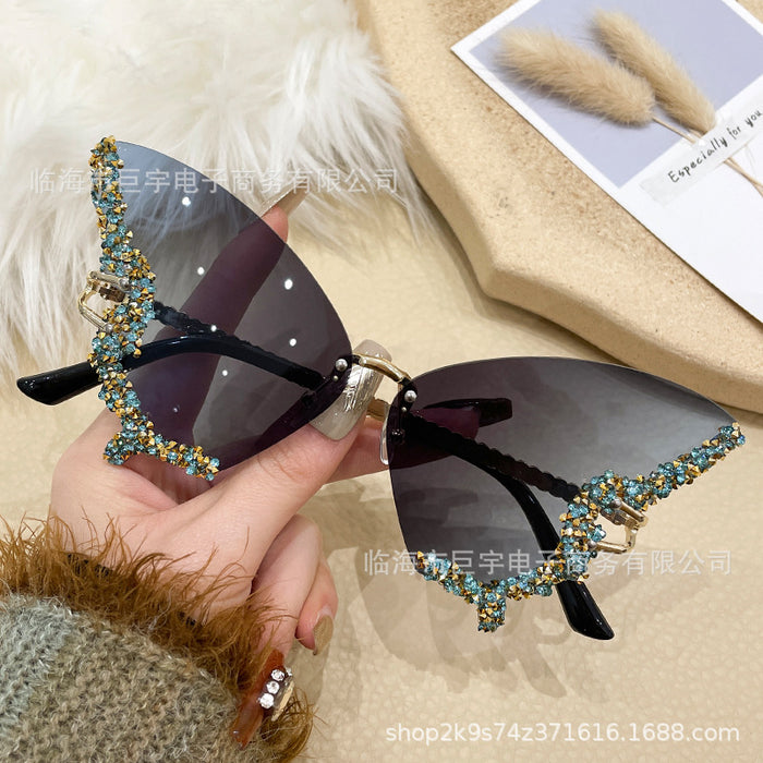 Wholesale Butterfly shaped diamond studded frameless sunglasses for women with fashionable personality and exaggerated sunglasses