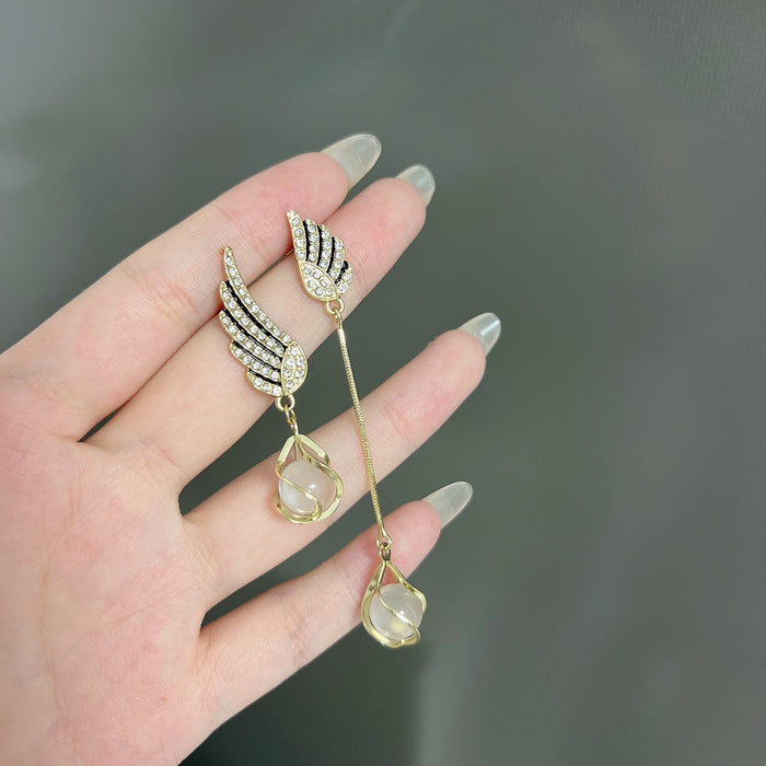 Wholesale Trendy AB asymmetrical diamond studded wing tassel cat eye stone earrings with atmospheric and exquisite earrings