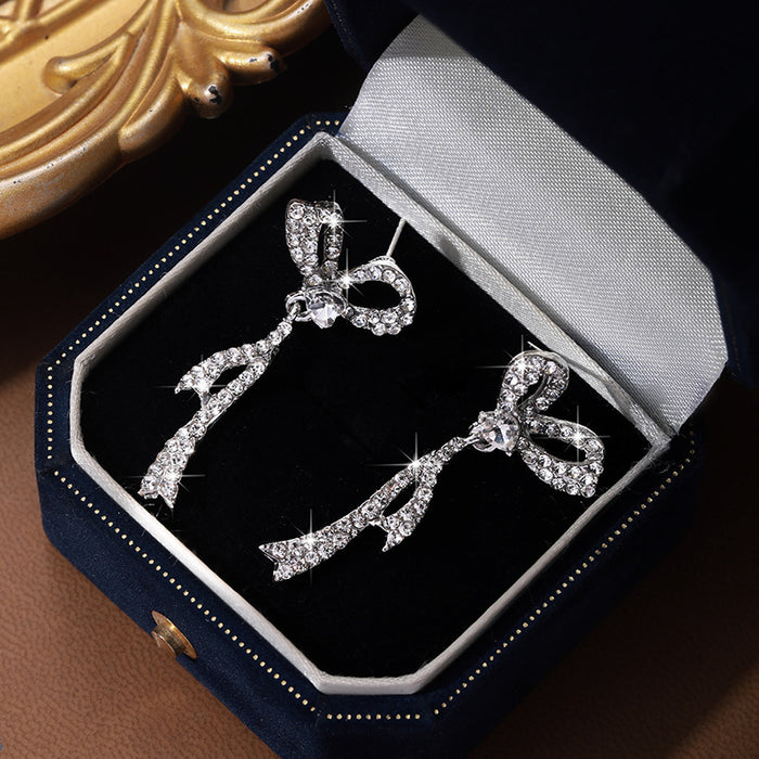 Wholesale Silver needle bow tassel earrings for women