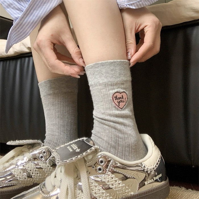 Wholesale Hollow out thin heart-shaped embroidered socks in a pile, tube socks