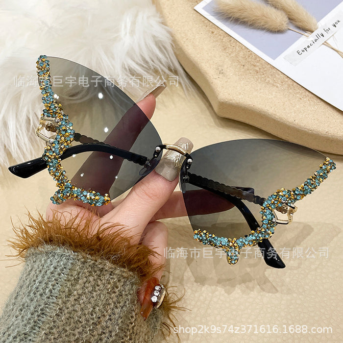 Wholesale Butterfly shaped diamond studded frameless sunglasses for women with fashionable personality and exaggerated sunglasses