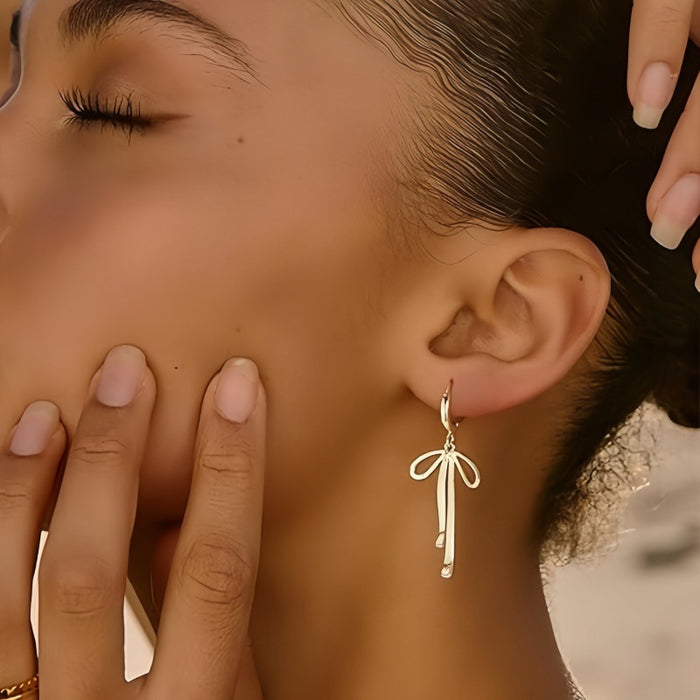 Wholesale Fashionable long bow pendant, ear buckle, ear ring, tassel shaped high-end earrings, brass genuine gold electroplating