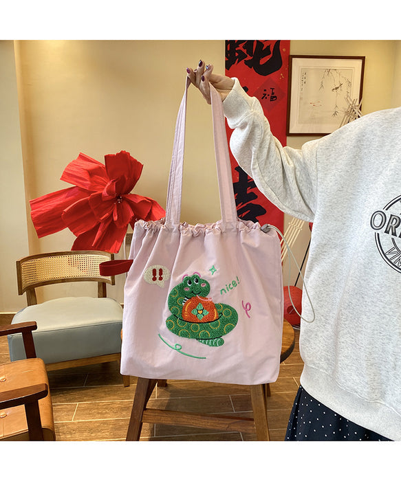 Wholesale Niche cartoon embroidered shoulder bag, simple and large capacity drawstring canvas bag, commuting tote bag for work