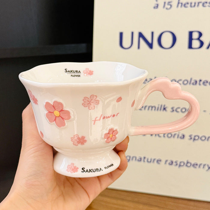 Wholesale Pink ceramic stemmed cup with cherry blossom relief design and spoon