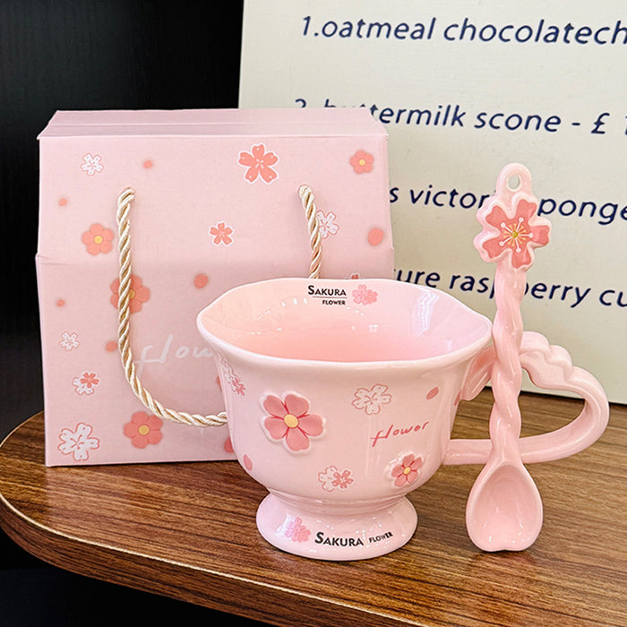 Wholesale Pink ceramic stemmed cup with cherry blossom relief design and spoon