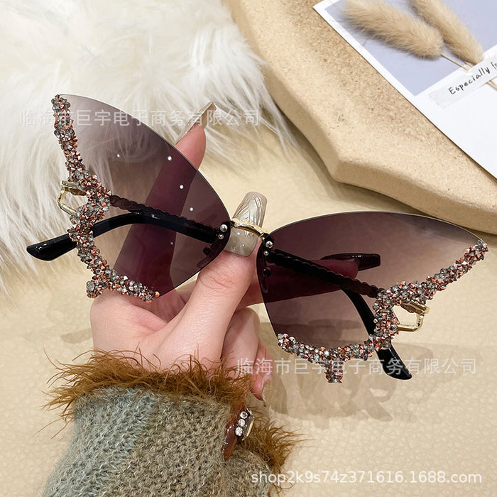 Wholesale Butterfly shaped diamond studded frameless sunglasses for women with fashionable personality and exaggerated sunglasses