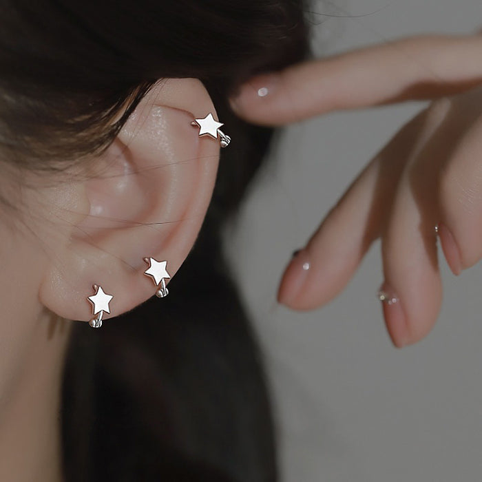 Wholesale Earrings with fashionable ear loops, niche smooth surface design, simple star shaped earrings