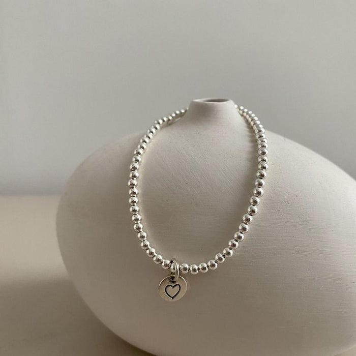 Wholesale Pure silver heart-shaped round bead bracelet with a new niche design, high-end feel, and light luxury bracelet accessories
