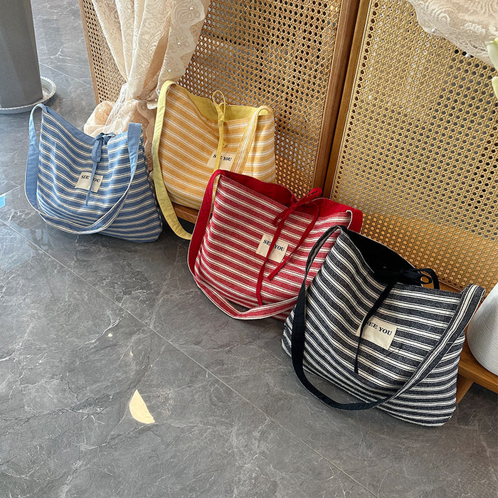 Wholesale Canvas striped large capacity fashionable simple versatile crossbody bag for work commuting tote bag