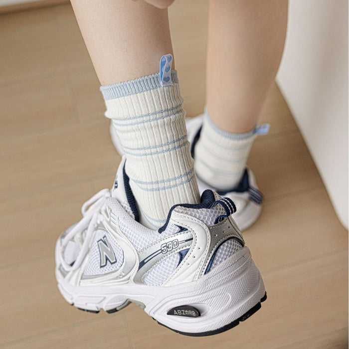 Wholesale Striped mid tube socks with heart-shaped fabric label, double needle long tube stacked socks
