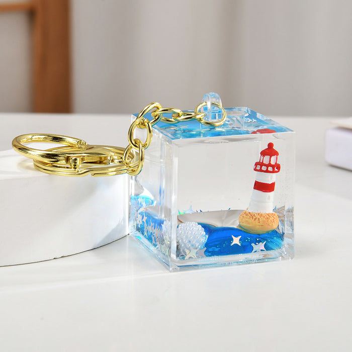Wholesale Acrylic sailboat lighthouse blue oil-filled quicksand bottle keychain