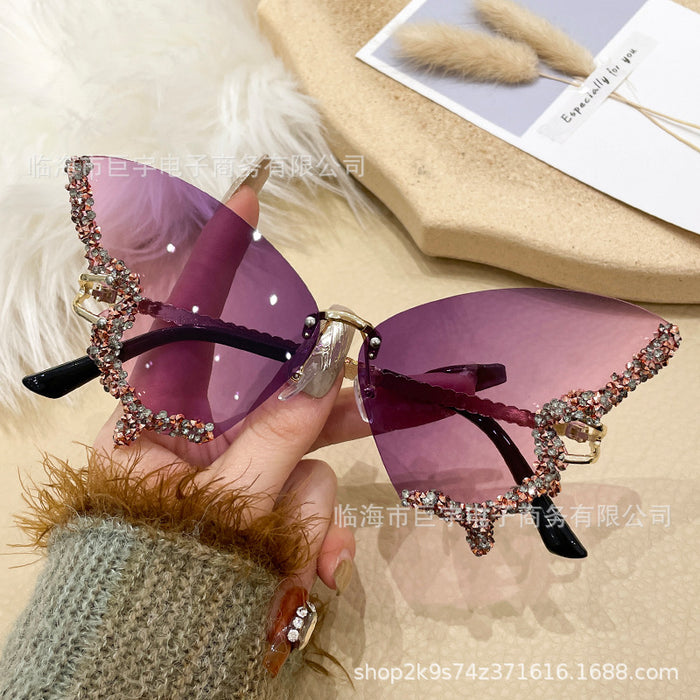 Wholesale Butterfly shaped diamond studded frameless sunglasses for women with fashionable personality and exaggerated sunglasses