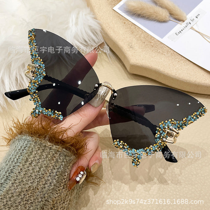Wholesale Butterfly shaped diamond studded frameless sunglasses for women with fashionable personality and exaggerated sunglasses