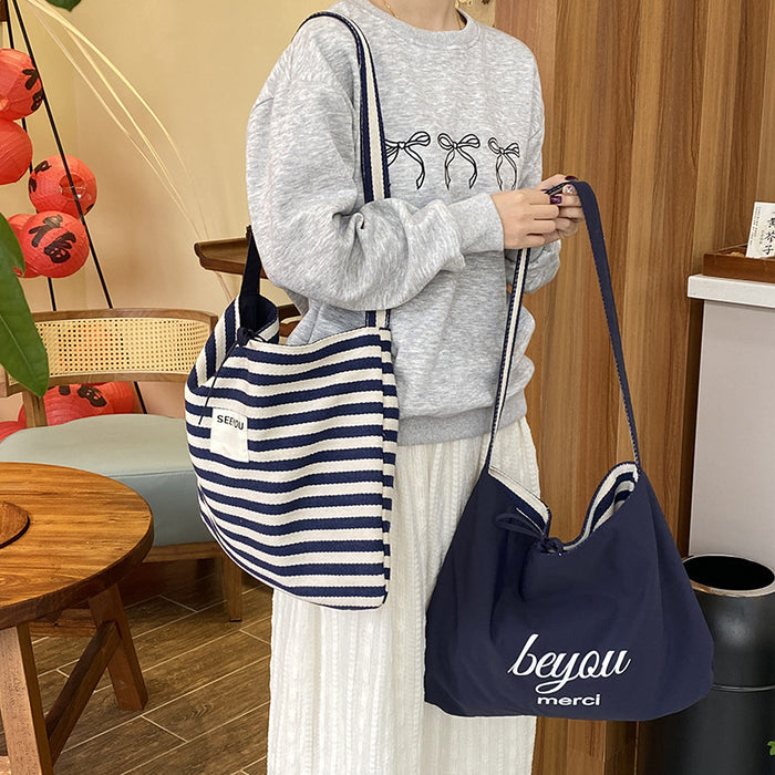 Wholesale New fashionable striped canvas bag with simple and large capacity letter printed double-sided crossbody bag, casual commuting shoulder bag